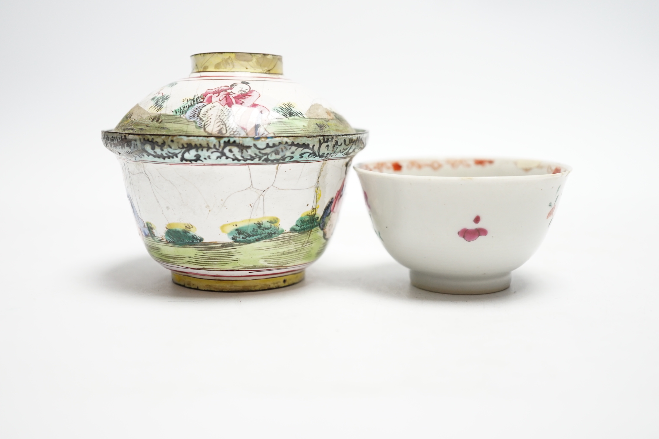 A Chinese Canton enamel tea bowl and cover, and a porcelain tea bowl, largest 8cm high